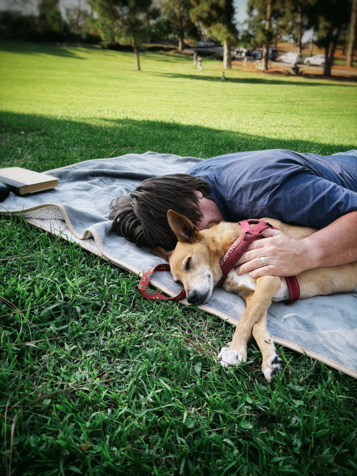 Eric lying with Herb in a park, both at peace
